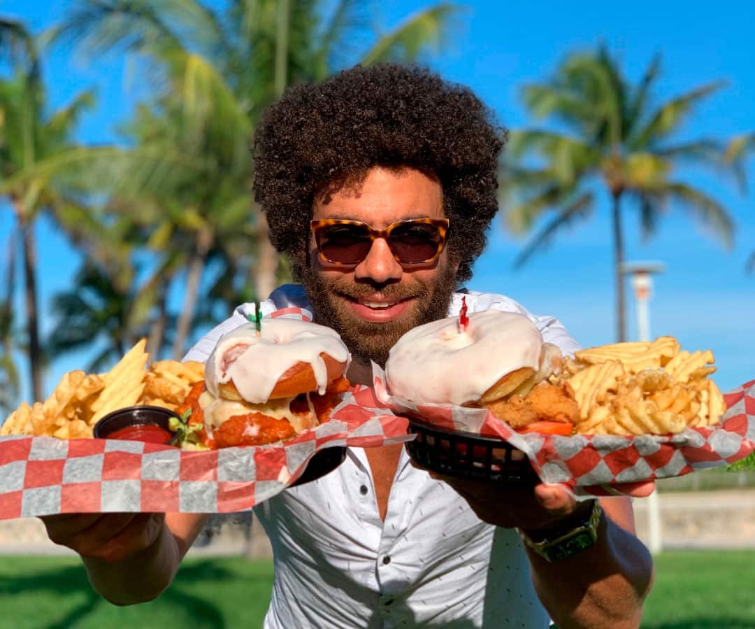 Blake showing 2 plates with fries and burgers