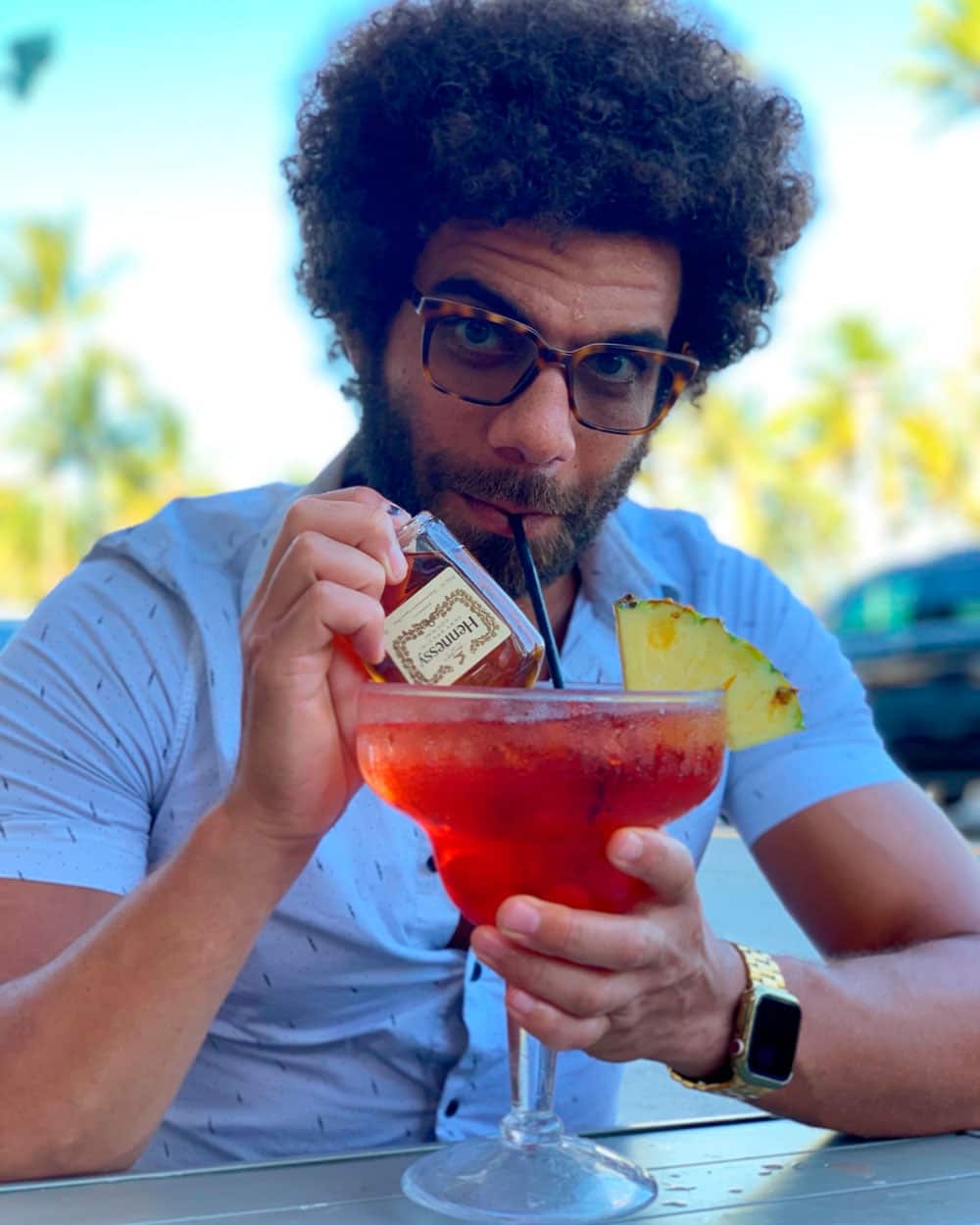 Blake sipping on a cocktail